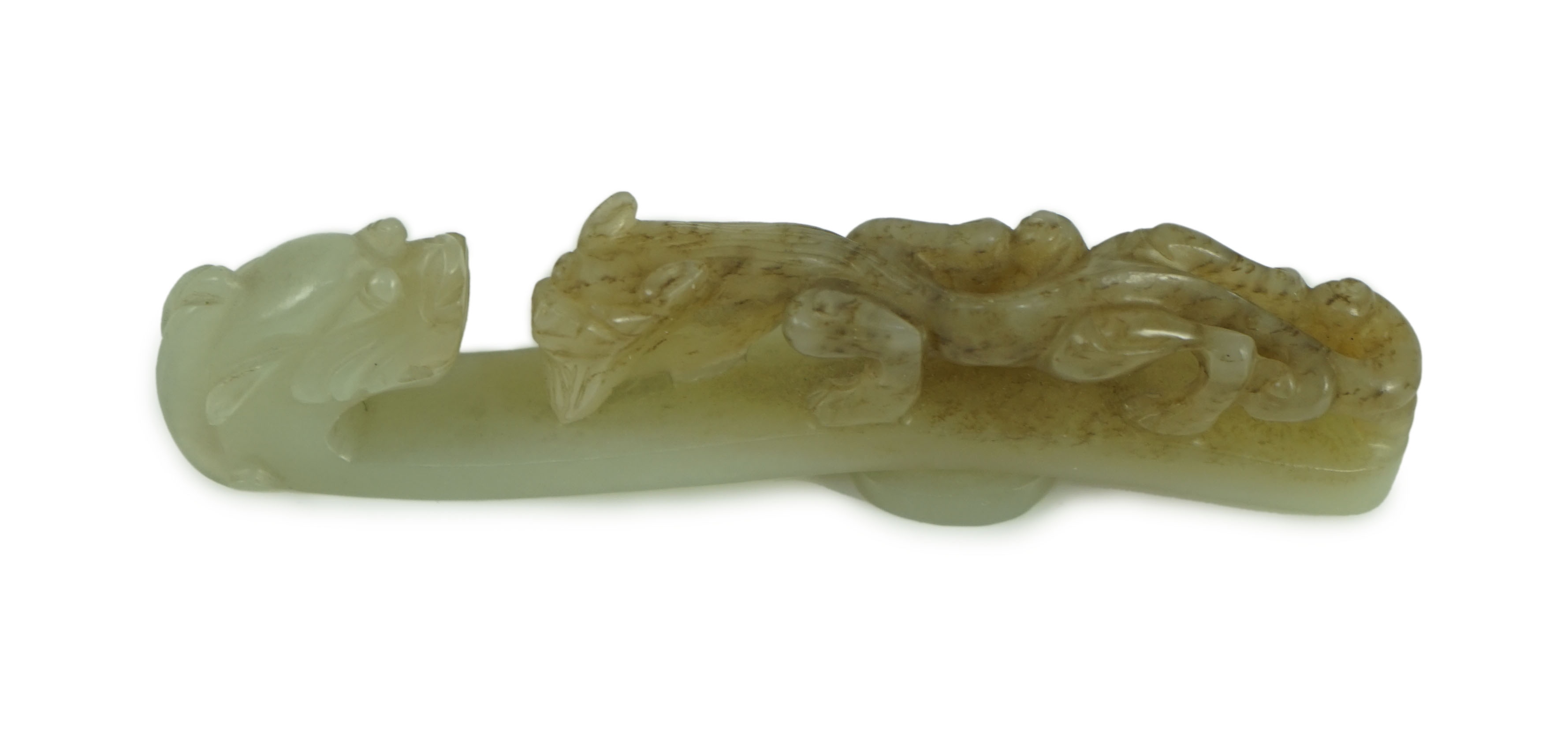 A Chinese pale celadon and brown jade ‘dragon’ belt hook, 18th/19th century 10.7 cm long